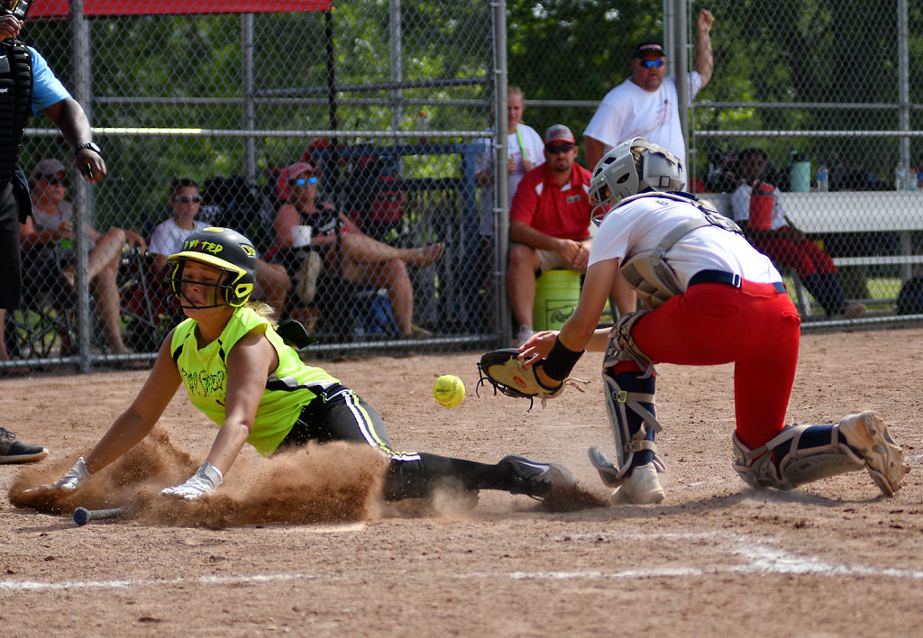 Tasia Green, 15, slides into home base before Rylee Boshell, 15, is able to tag her out
